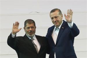 Turkey's PM and leader of ruling AKP Erdogan and Egypt's President Mursi greet the audience during the AKP congress in Ankara