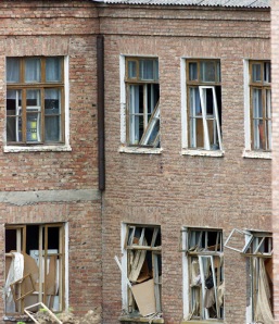 Broken windows are seen at the rear of a school building seized by heavily armed masked men and ...