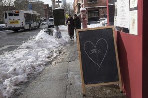 An 'Open' sign sits outside a restaurant near Fort Greene Park in Brooklyn after a snow storm in New York