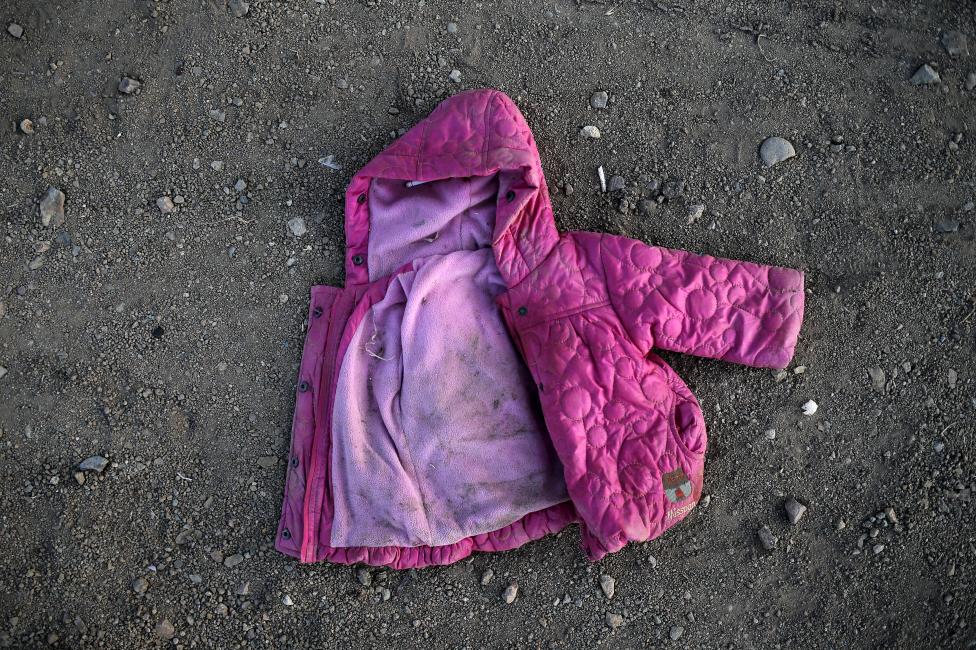 A baby jacket is seen on a street next to a beach where refugees and migrants arrived on dinghies, on the Greek island of Lesbos